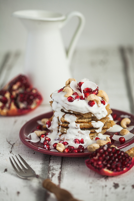 Recipe for Cashew Butter Coconut Milk Pancakes with a Curd Coconut Topping garnished with Cashew Seeds and Pomegranate. Foodstyling and Recipe from Purple Avocado / Sabrina Dietz