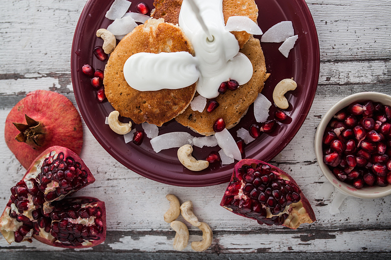 Recipe for Cashew Butter Coconut Milk Pancakes with a Curd Coconut Topping garnished with Cashew Seeds and Pomegranate. Foodstyling and Recipe from Purple Avocado / Sabrina Dietz