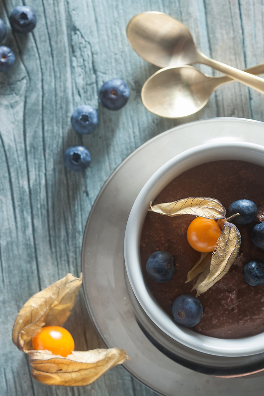 Recipe for vegan chocolate mousse made of silken tofu with peanut butter, blueberries and physalis.