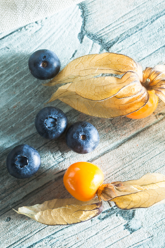 Recipe for vegan chocolate mousse made of silken tofu with peanut butter, blueberries and physalis.