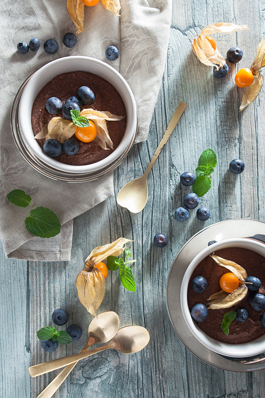 Recipe for vegan chocolate mousse made of silken tofu with peanut butter, blueberries and physalis.