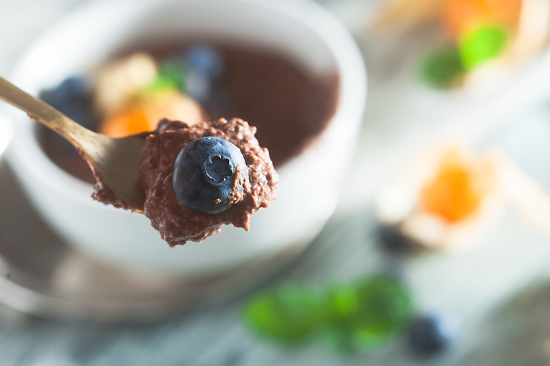 Recipe for vegan chocolate mousse made of silken tofu with peanut butter, blueberries and physalis.