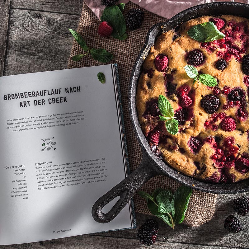 An ethnic recipe for a vegan berry cake freely adapted from a recipe of the Ethno Cookbook by Karolina Przybylska with lots of fresh berrys and maple syrup.