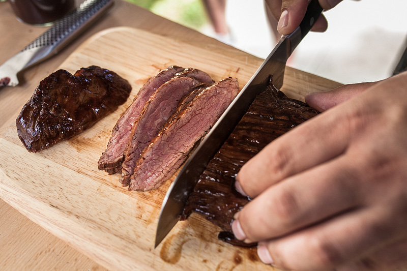 a beautiful flank steak - A summer recipe for hot barbecue evenings: a light and crips soy sprouts salad à la surf'n'turf with prawns and flank steak from the grill. Food styling and food photography by Purple Avocado.