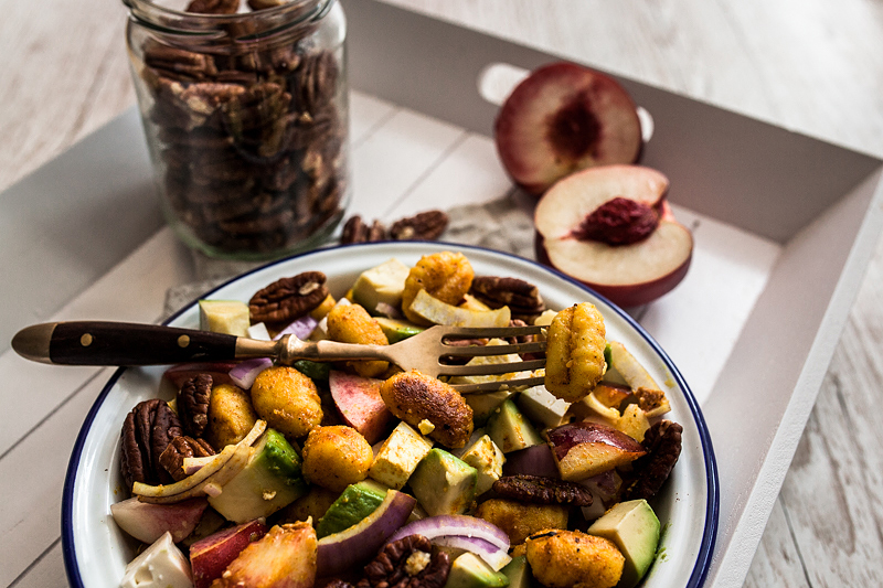 Quick and satisfying Curry Gnocchi Salad with nectarines, feta cheese, roasted pecan nuts and creamy avocado. The perfect summer salad that can be savoured warm and cold and is perfectly suited to be taken out for picnics or barbecue with friends. Recipe and food styling from Purple Avocado / Sabrina Dietz