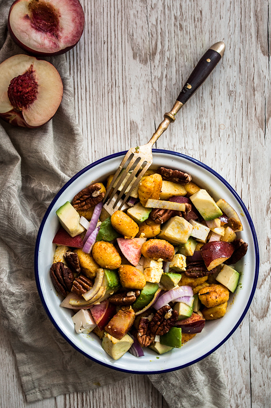 Quick and satisfying Curry Gnocchi Salad with nectarines, feta cheese, roasted pecan nuts and creamy avocado. The perfect summer salad that can be savoured warm and cold and is perfectly suited to be taken out for picnics or barbecue with friends. Recipe and food styling from Purple Avocado / Sabrina Dietz