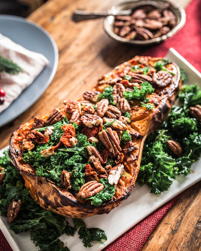 Stuffed pumpkin with kale, pecan nuts, dried tomatoes and a rich almond butter sauce. #vegan #recipe #christmas #holidays #autumn #winter #kale #foodstyling #food #photography