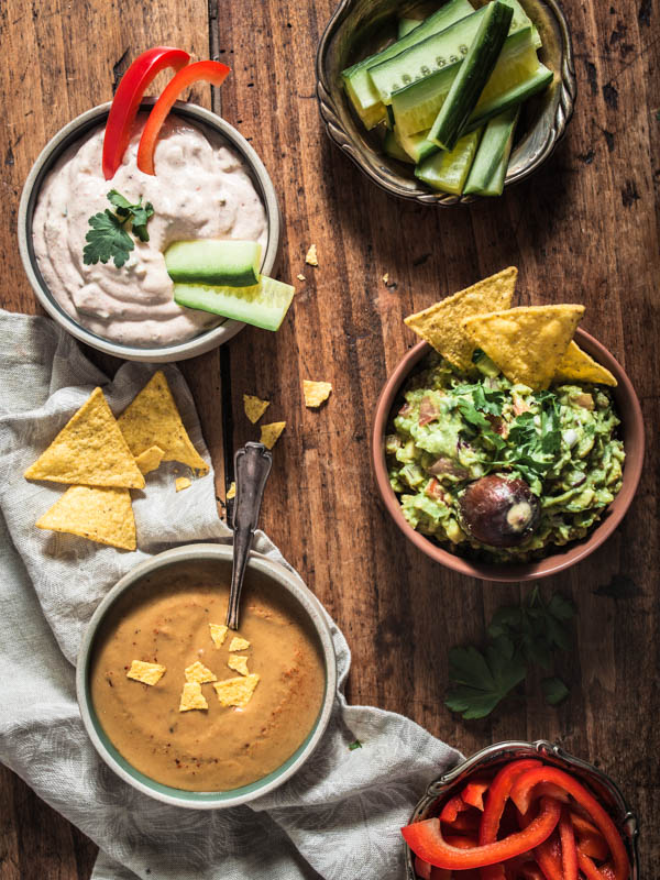 Mexican party food: 3 vegan dips for tacos, tortillas and nachos. Guacamole, Sour cream and cheesy queso dip with egg plant