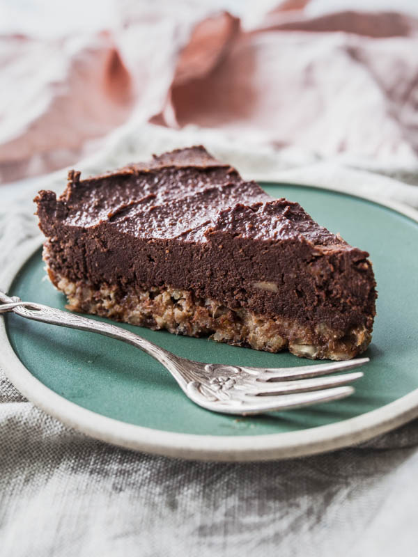 A piece of chocolate cake on a green plate