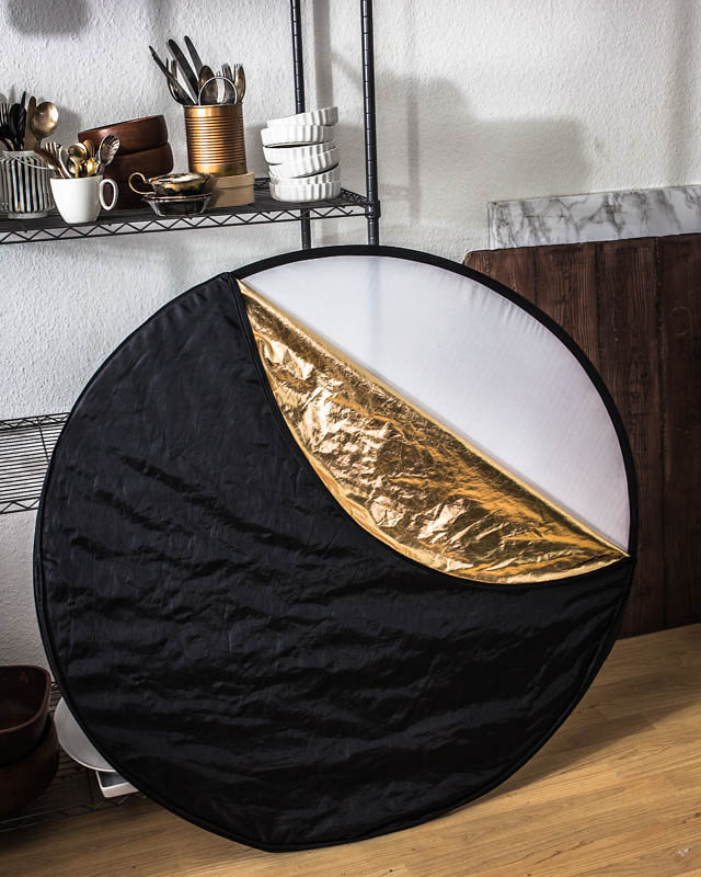 Collapsible reflector with golden, silver, black and white surface
